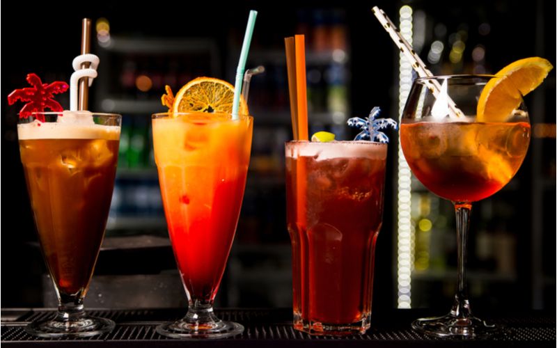 Míchané nápoje a kalorie - řada míchaných drinků na barovém pultu